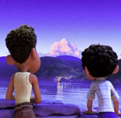 two little boys sitting on rocks looking at the water and mountains in the distance with purple sky