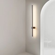 a white room with a light on the wall