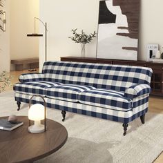 a blue and white checkered couch sitting in a living room next to a table