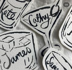 six stickers with the names of different types of food and beverages on them, all written in black ink