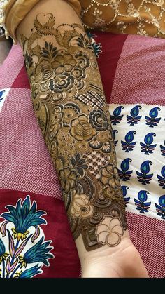 a woman's arm covered in henna