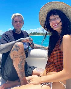 a man and woman sitting on the back of a boat