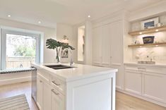 a kitchen with white cabinets and an island