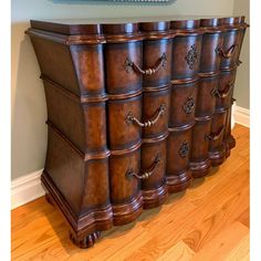 an ornate wooden dresser with many drawers