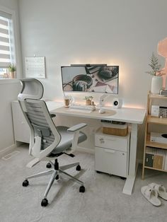 a white desk with a computer on top of it