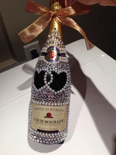 a close up of a bottle of wine with a bow on it's head