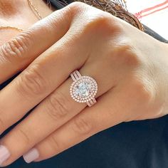 a woman's hand with a diamond ring on it