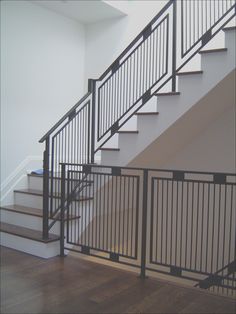 an empty room with stairs and railings