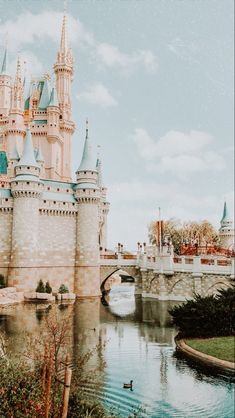 an old photo of a castle with swans in the water