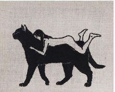 a woman laying on top of a black cat