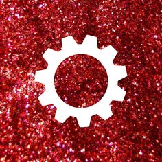 a red glitter background with a white circular object in the middle