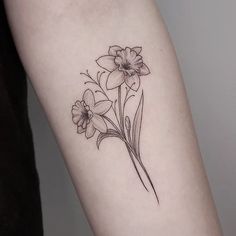 a black and white photo of flowers on the left arm, with one flower in the middle