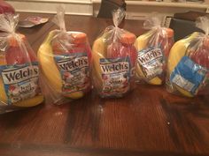 four bags of packaged food sitting on top of a wooden table