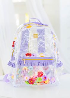 Carry your essentials in style with our Bree Clear Backpack - Floral Frenzy. This quirky vinyl backpack features a fun trapped flower design. Stay organized while showing off your playful side. (Flower power not included!) Disclaimer: Please be aware that the orientation of flowers placed inside a backpack may change or flip. The artificial flowers come with a stem piece attached for stability. Standard Size: 16" H x 12.5" W x 6.5" D Standard size backpack easily holds folders or 3-ring binders Everyday Plastic Backpack, Everyday Use Plastic Backpack, Plastic Backpack For Everyday Use, Plastic Travel Backpack, Back To School Plastic Backpack, Back To School Plastic Standard Backpack, Standard School Backpack In Plastic, Back To School Standard Plastic Backpack, Plastic Standard Backpack For School