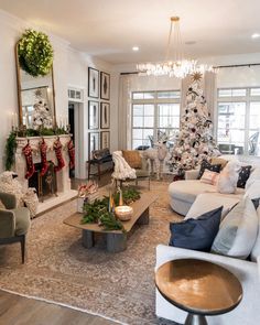 a living room filled with furniture and a christmas tree in the middle of the room