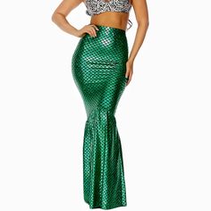 a woman in a green mermaid skirt and crop top with her hands on her hips