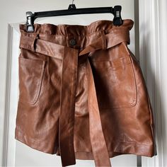 Brown Faux Leather High Waisted Shorts With Tie At The Waist. Brand Is Alya, But I Think It Was Purchased At Francesca’s - Size Medium. New Without Tags - From A Non-Smoking But Pet Friendly Household High Waist Brown Shorts With Belt Loops, Brown High Waist Shorts With Belt Loops, Chic Brown Belted Bottoms, Brown Faux Leather Short Bottoms, Chic Brown Paperbag Waist Bottoms, Chic Brown Shorts With Belt Loops, Faux Leather Mini Skirt With Pockets, High Waist Faux Leather Shorts With Pockets, Brown Faux Leather Shorts For Night Out