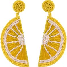 a pair of yellow and white beaded earrings with an orange slice in the center