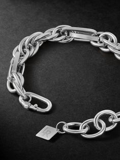 Classic jewellery often serves as a starting point for Lauren Rubinski, which she personalises and modernises through her unique design. This bracelet is cast from white gold using a variety of chain links, creating contrasting shapes and dimensions. It's understated enough to make your everyday signature. Luxury Stainless Steel Chain Bracelet With Rectangular Links, Timeless White Gold Chain Link Bracelet, Classic White Gold Metal Chain Bracelet, Timeless White Gold Link Bracelet, Timeless Link Bracelet With Polished Finish, Timeless Link Bracelets With Polished Finish, Elegant Metal Chain Bracelet With Polished Finish, Timeless Silver Chain Bracelet, Luxury Sterling Silver Bracelet With Oval Link