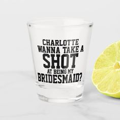 a shot glass with the words charlotte wanna take a shot at being my bridesmaid?