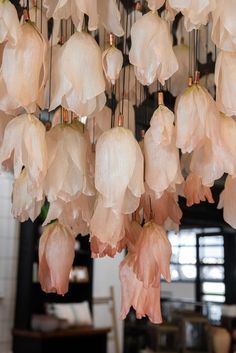 pink flowers hanging from the ceiling in a room