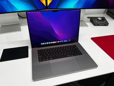 an open laptop computer sitting on top of a white desk