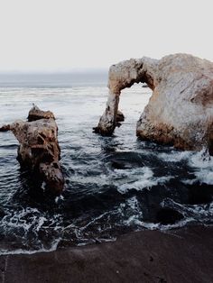 two large rocks sticking out of the ocean