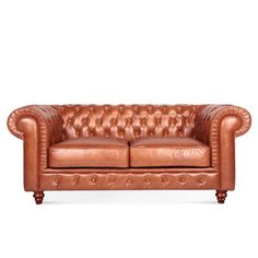 a brown leather couch sitting on top of a white floor