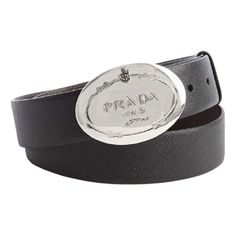 This belt is crafted with a black saffiano leather. The oval engraved Prado logo silver buckle is such a statement piece with the Prada logo. This Prada belt is so classic and goes great with every look!     Model: 2CM046  Size: 110/44  Black Saffiano Leather  Silver-toned hardware  Palladium plaque buckle  Includes Prada authenticity card and dust bag  Made in Italy Silver Leather Belt With Logo Plaque, Silver Leather Belt Buckle With Logo Plaque, Elegant Black Belt With Silver-tone Logo, Classic Leather Belt With Silver-tone Logo Plaque, Designer Black Belt Buckle With Silver-tone Logo, Designer Black Belt Buckles With Silver-tone Logo, Elegant Silver Belt With Metal Logo, Luxury Black Belt With Silver-tone Logo Plaque, Luxury Black Belt With Silver-tone Logo