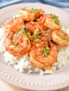 shrimp and rice on a plate with parsley