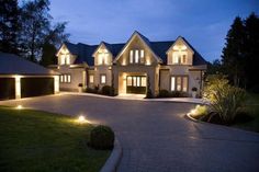 a large house lit up at night with lights on