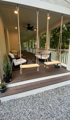 a porch with swings and chairs on it