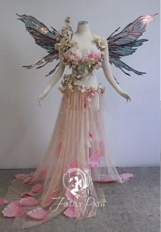 a mannequin with flowers and wings on display