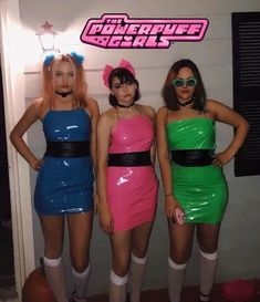 three women dressed up in costumes standing next to each other