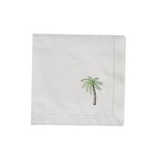 a white napkin with a palm tree embroidered on it