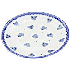 a blue and white plate with flowers on the rim, sitting in front of a white background