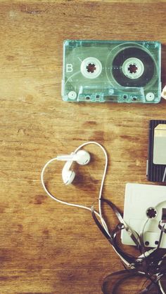 an old fashioned cassette player and headphones on a wooden table