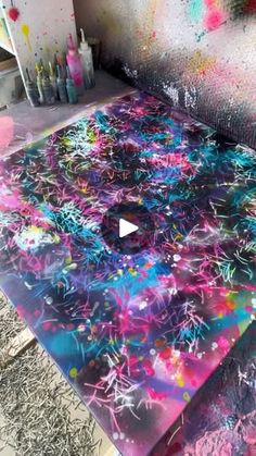 a table covered in lots of colorful paint