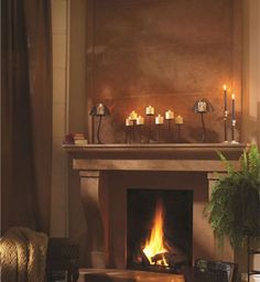 a living room with a fire place and candles