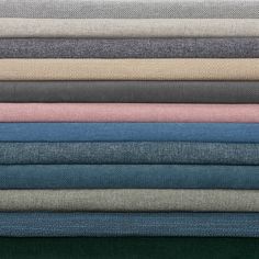 a stack of different colored linens on top of each other in various sizes and colors