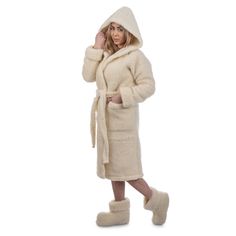 Bathrobe made of 100% wool knitwear that does not cause skin irritation. This classic model for men and women is finished with a classic model with hood and pockets, has a belt and two side pockets located in the side seams.  Through heating and gentle massage, it reduces muscle tension, relieves pain of rheumatic origin. The highest class of finish and detailed refinement will certainly give you maximum comfort with your morning coffee or evening tea.  Wool products are intended for people suffering from certain rheumatic conditions, as well as for those who attach importance to a healthy lifestyle. The products made of woolen knitwear manufactured by us are recommended for healthy people as a natural prophylactic product, ensuring healthy rest. In addition, they help in the treatment of Cozy Cream Sweater Coat For Loungewear, Cozy Hooded Robe For Winter, Cozy Hooded Winter Robe, Cream Sweater Coat For Winter Loungewear, Cozy Winter Home Robe, Cozy Long Sleeve Winter Robe, Cozy White Robe For Winter, Cozy White Winter Robe, White Long Sleeve Winter Robe