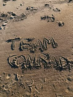 the word team forward written in the sand