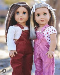 two dolls are standing next to each other