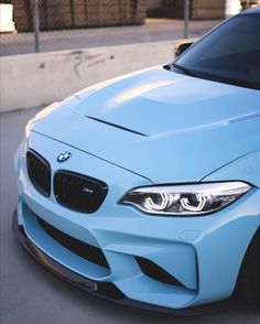 a blue bmw car parked on the street