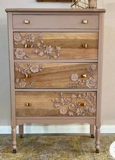 a wooden dresser with flowers painted on it