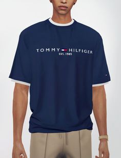 a man wearing a tommy hilfiger t - shirt and khaki pants