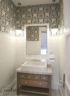 a bathroom with a sink and mirror in it