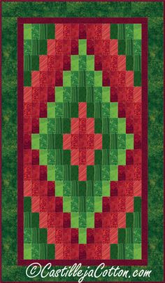 a green and red quilted wall hanging