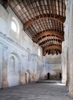 the inside of an old building with stone walls and arched doorways on both sides