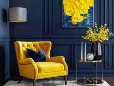 a living room with blue walls and yellow chair in the corner, vases on table